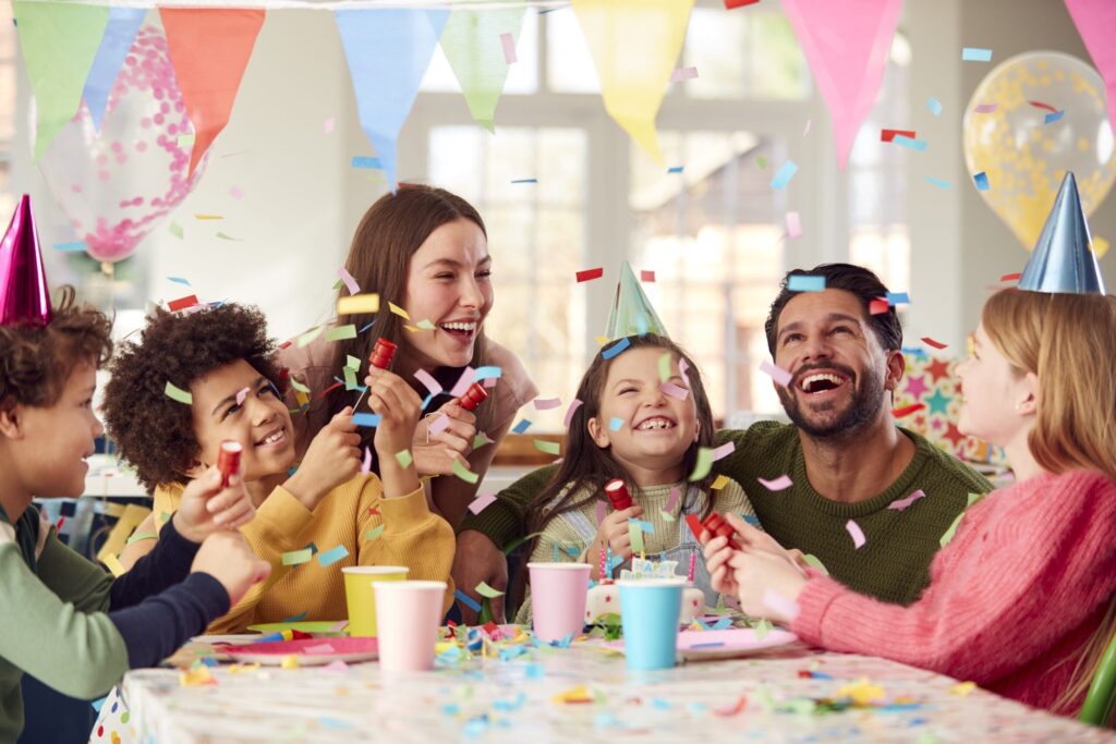 girl with parents friends home celebrating birthday firing confetti poppers party scaled 1 Inventory
